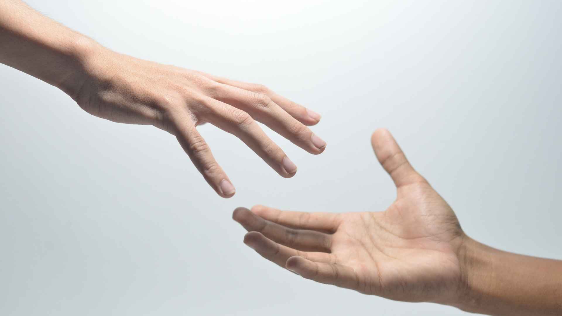2 hands reaching for each other